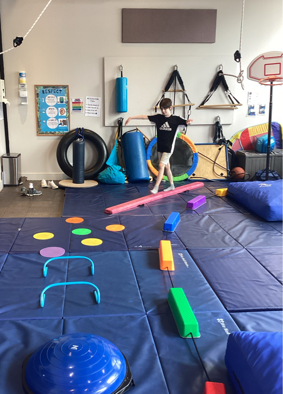 Best Sensory Gym for OT Services in Chicago Child doing a motor activity in sensory gym