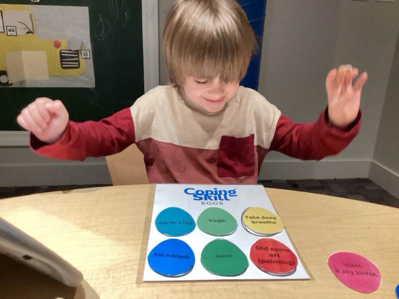 A child doing therapy activity at the tabletop.