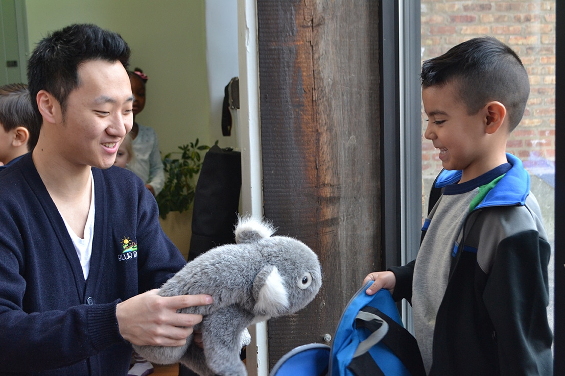 Child and therapist with stuffed animal koala